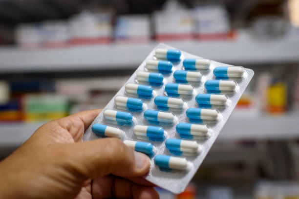 istock Pills in the package. Hand holding pills in a pharmacy with a blurred background. 1379245808