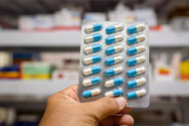 istock Pills in the package. Hand holding pills in a pharmacy with a blurred background. 1379246321
