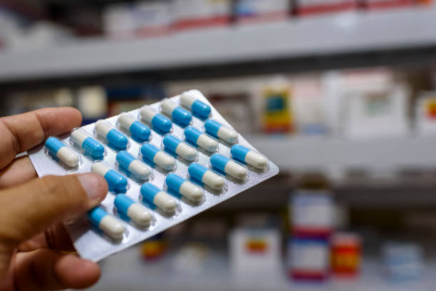 istock Pills in the package. Hand holding pills in a pharmacy with a blurred background. 1379246328
