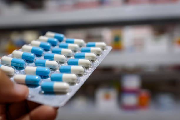 istock Pills in the package. Hand holding pills in a pharmacy with a blurred background. 1379246334