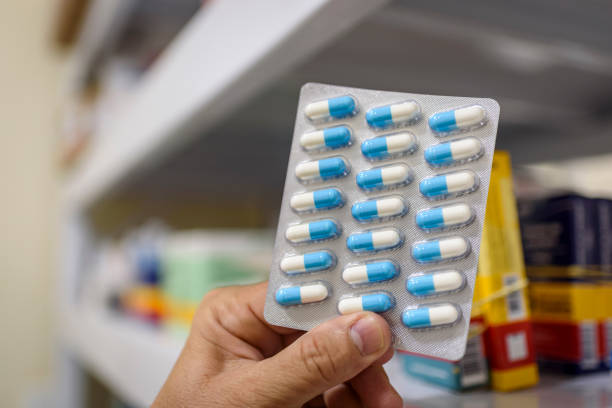 istock Pills in the package. Hand holding pills in a pharmacy with a blurred background. 1379246340
