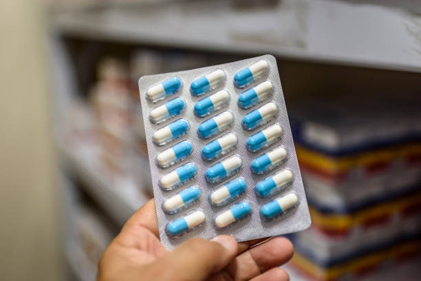 istock Pills in the package. Hand holding pills in a pharmacy with a blurred background. 1379246342