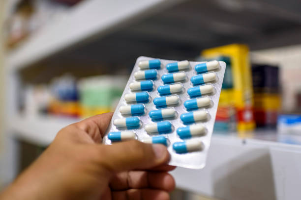 istock Pills in the package. Hand holding pills in a pharmacy with a blurred background. 1379246343