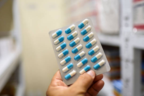 istock Pills in the package. Hand holding pills in a pharmacy with a blurred background. 1379246345