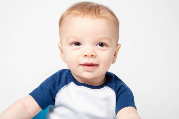 A 6 month old baby boy smiling.