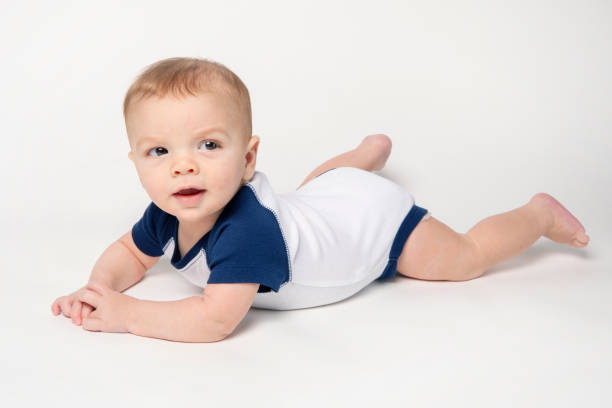 istock Six Month Old Baby Boy Laying on Belly 1379250512