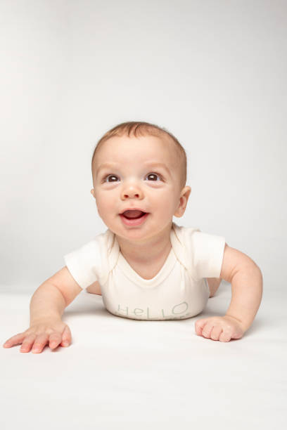istock Six Month Old Baby Boy on Belly Smiling 1379254191