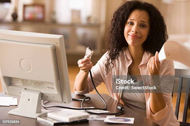 Confused Woman Reading Instructions On How To Build Pc Stock Photo - Download Image Now
