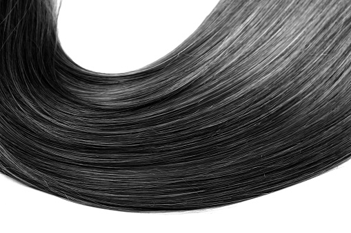 A strand of shiny healthy black hair