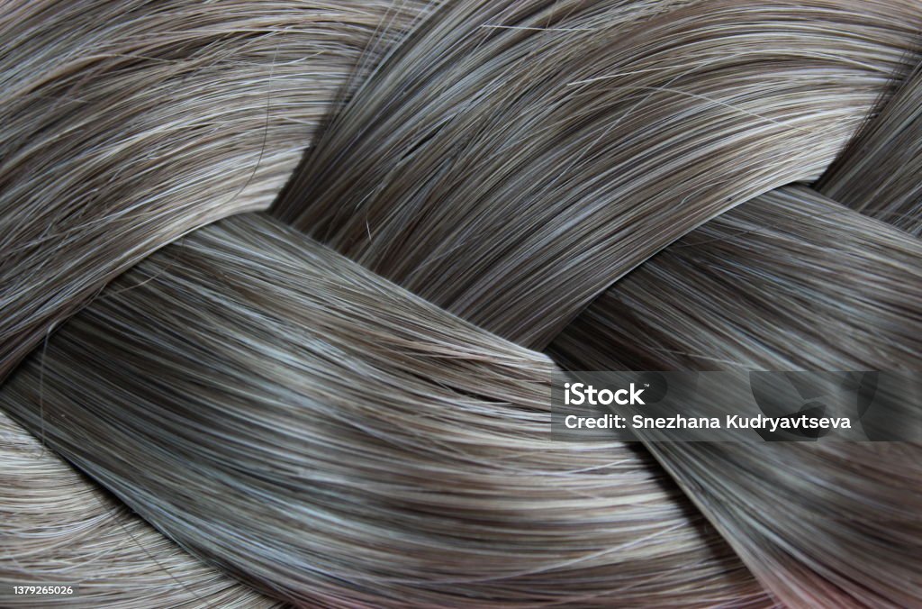 Texture close-up of braided hair gray color background Gray Hair Stock Photo