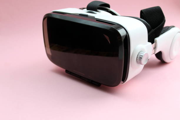 istock Virtual reality glasses of white color on a pink background 1379265568
