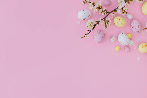 istock Easter flat lay with space for text. Colorful Easter chocolate eggs and cherry blossoms border on pink background. Happy Easter!. Stylish tender spring banner template. Greeting card 1379285195