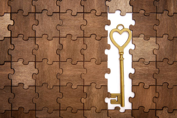 istock Heart shaped skeleton key on a puzzle background 1379295432