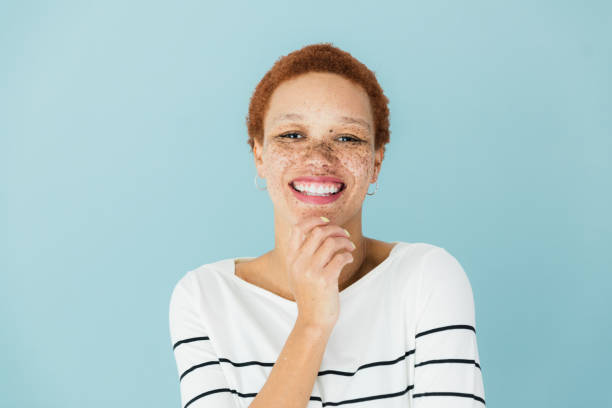 istock Female creative professional rests chin on hand and smiles 1379309444
