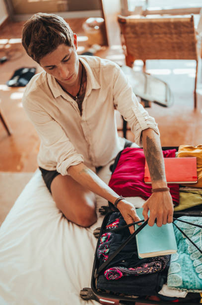 istock An urban young man is packing for the trip 1379314135