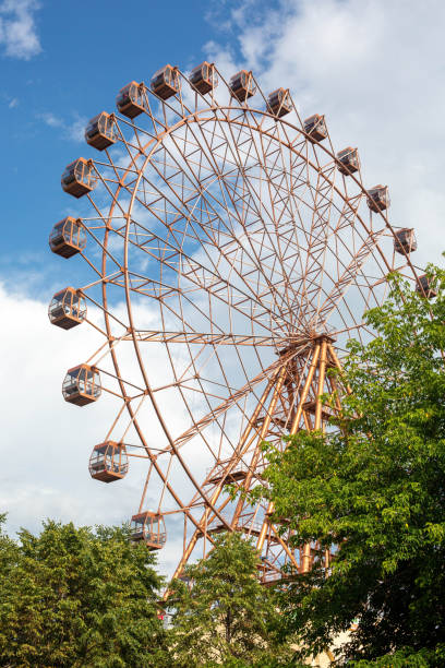 istock A big observation wheel in a city park against a blue sky with clouds. 1379314298