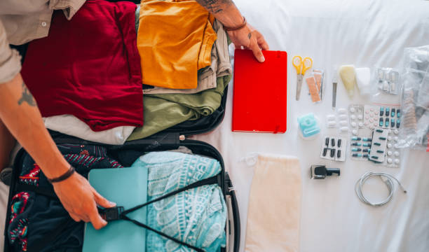 istock Directly above the man's hands packing for the trip 1379314316