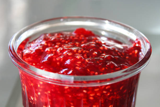 istock Fresh jam in a glass jar. Close-up. Top side view. Background. 1379318761