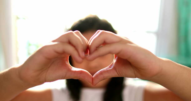 istock Mixed race girl child doing heart sign with hands 1379332121