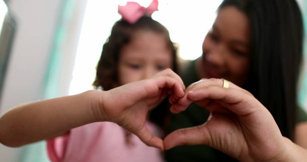 istock Mother and child doing heart symbol sign with hands 1379333850
