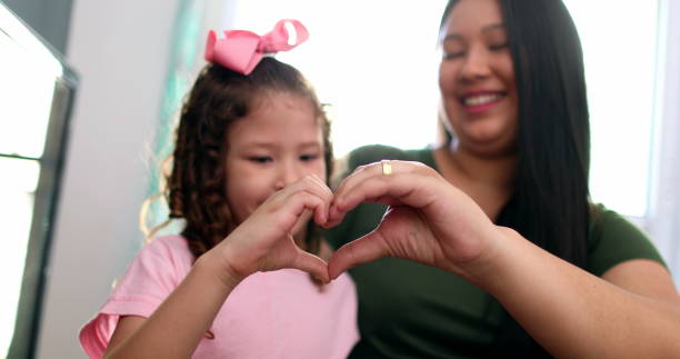 istock Mother and child doing heart symbol sign with hands 1379334011