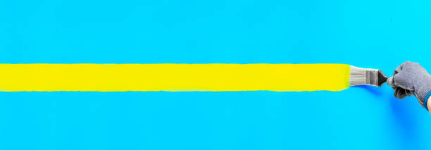 istock Yellow brush strokes painted on blue wall. 1379334046