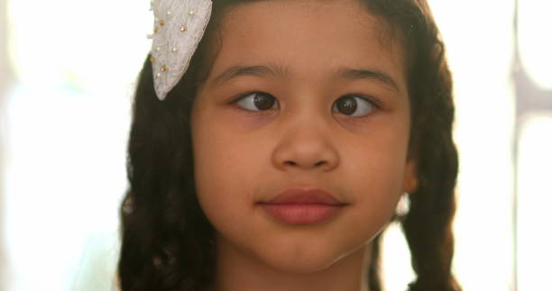 Funny little girl doing crossed eyes