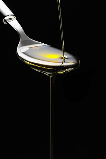 istock Olive oil being drizzled on a spoon on a black background 137933606