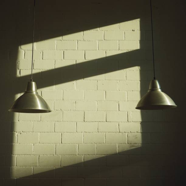 istock Two Pendant Lights in front of White Wall 1379354006