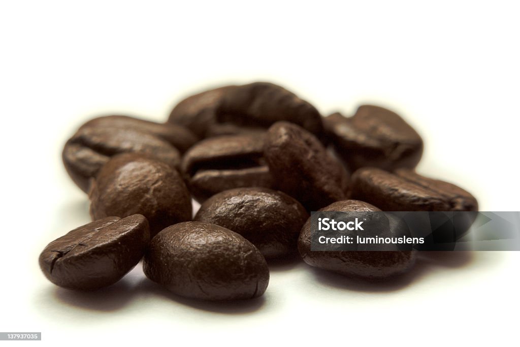 Coffee Beans Dark roasted coffee beans, isolated on white background.  Very shallow depth of field. Brown Stock Photo