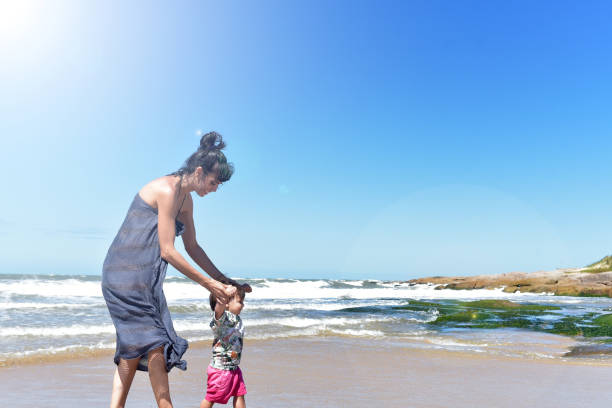 istock mother playing with her child on the beach 1379371250