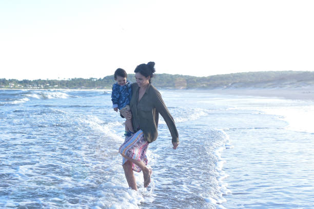 istock mother playing with her child on the beach 1379375493