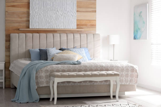 istock Comfortable bed with soft color pillows indoors 1379376531