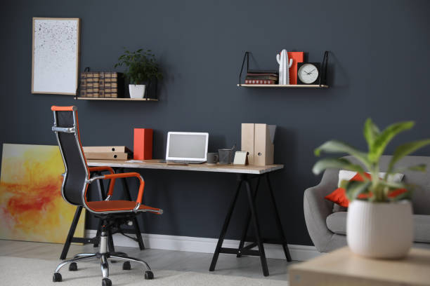 istock Modern workplace with comfortable chair in stylish home office interior 1379376536