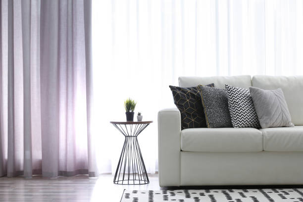 istock Comfortable sofa near window with elegant curtains in room 1379385849