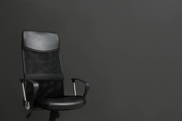 istock Comfortable office chair on black background. Space for text 1379388058