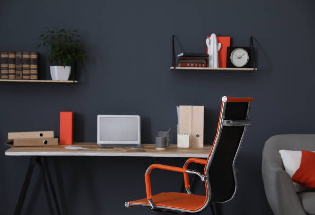 istock Modern workplace with comfortable chair in stylish home office interior 1379390380