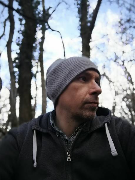 istock Sitting in the woods, looking thoughtfully away 1379390674