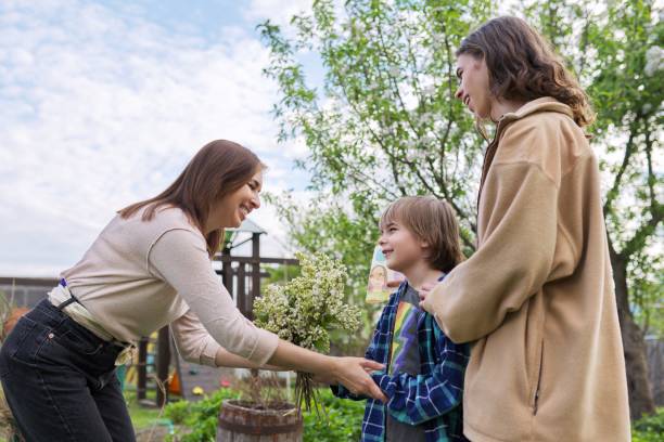 istock Mother's day concept. Two sons congratulating mom 1379399168