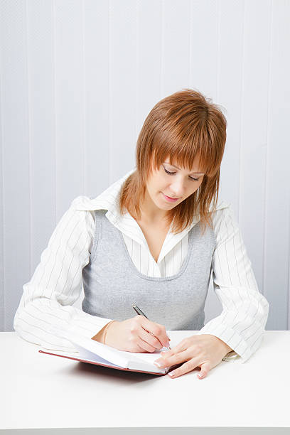 istock Attractive girl with a notepad and pen 137941887