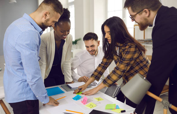 istock Mixed race diverse smart business team brainstorming planning use color sticker 1379422326
