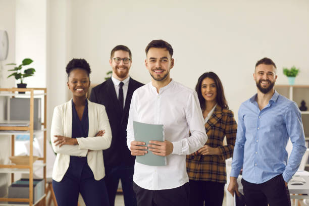 istock Confident business leader and diverse interracial team looking at camera smiling 1379422332