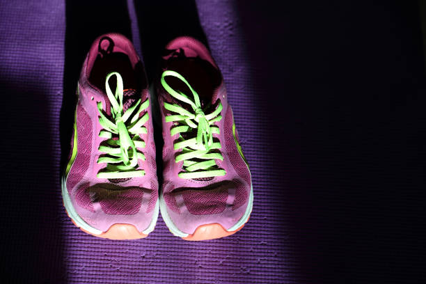 Home sports: old sneakers on a fitness mat