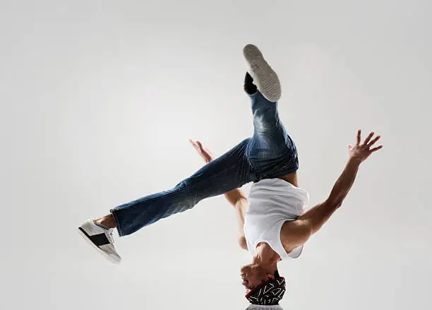 break dancer frozen in mid head spin, classic modern hip hop or break dance move
