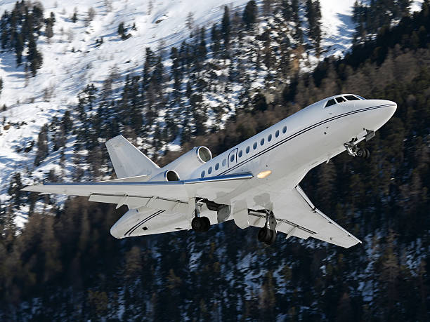 Business jet take-off with mountains stock photo