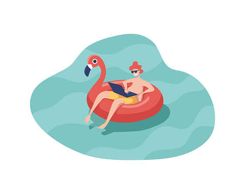 Man with laptop swiming on inflatable ring in the shape of a pink flamingo floating in the pool.