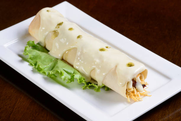 Chicken crepe with white sauce. stock photo