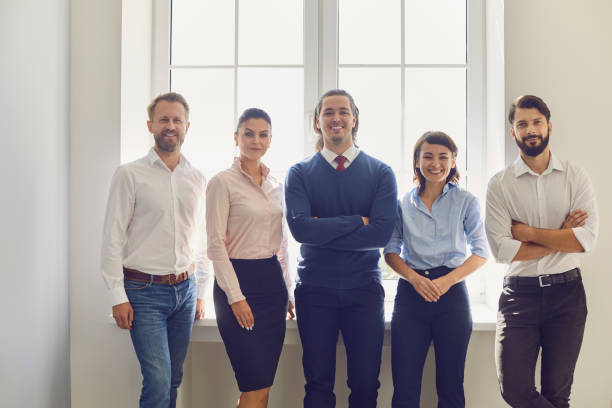 istock Portrait of a successful creative business team looking at the camera and smiling by the window. 1379449727
