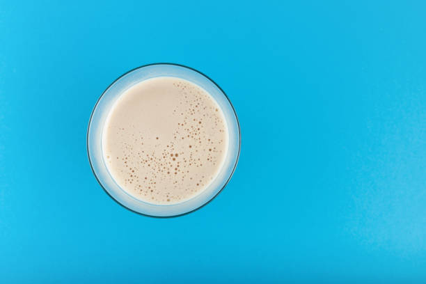 istock Coffee Cappuccino in glass. Hot coffee drink, top view. Blue background, copy space 1379450228