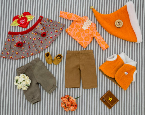 istock Clothes for a doll on a striped background. 1379480272